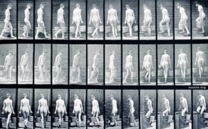 Woman with a bucket of water in each hand, ascending stairs